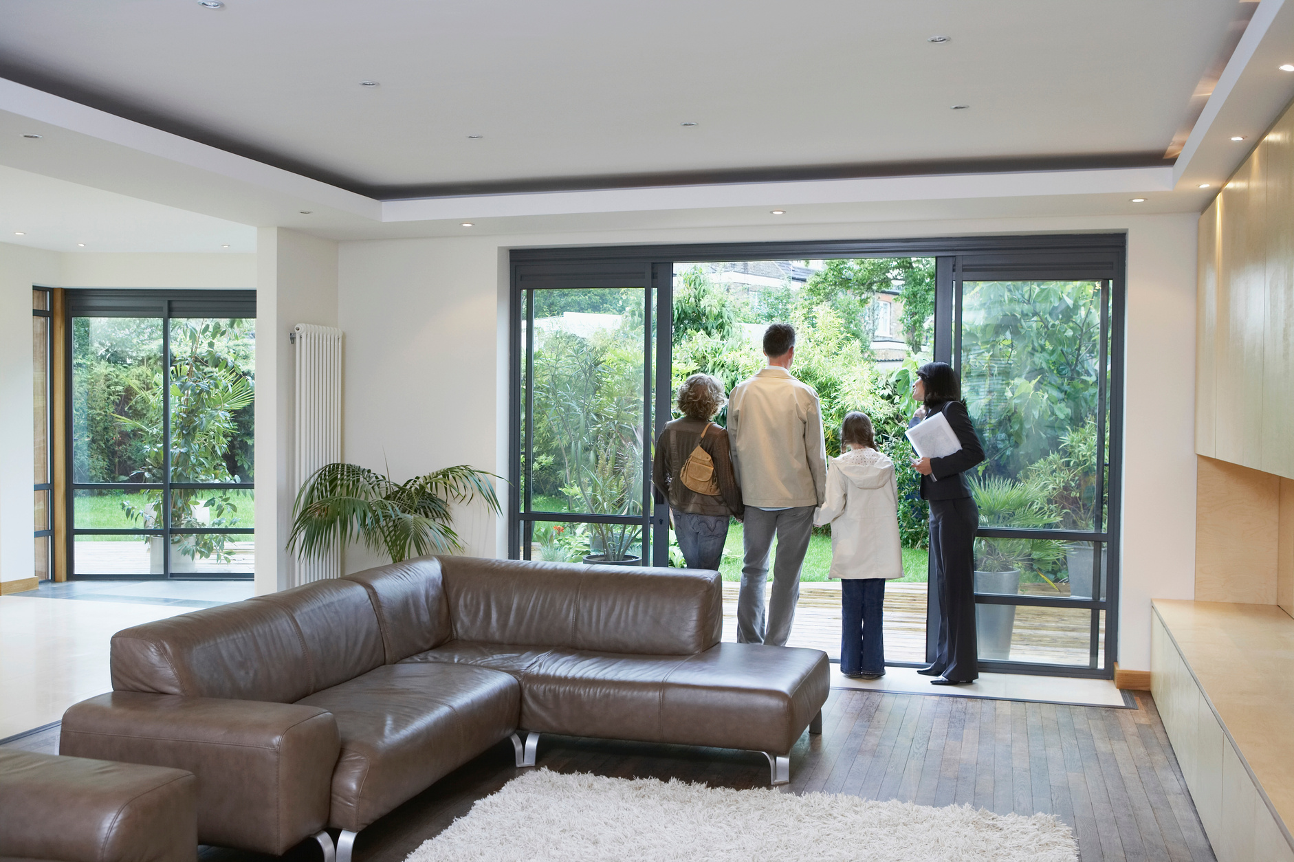 parents and daughter (7-9) with estate agent observing new property